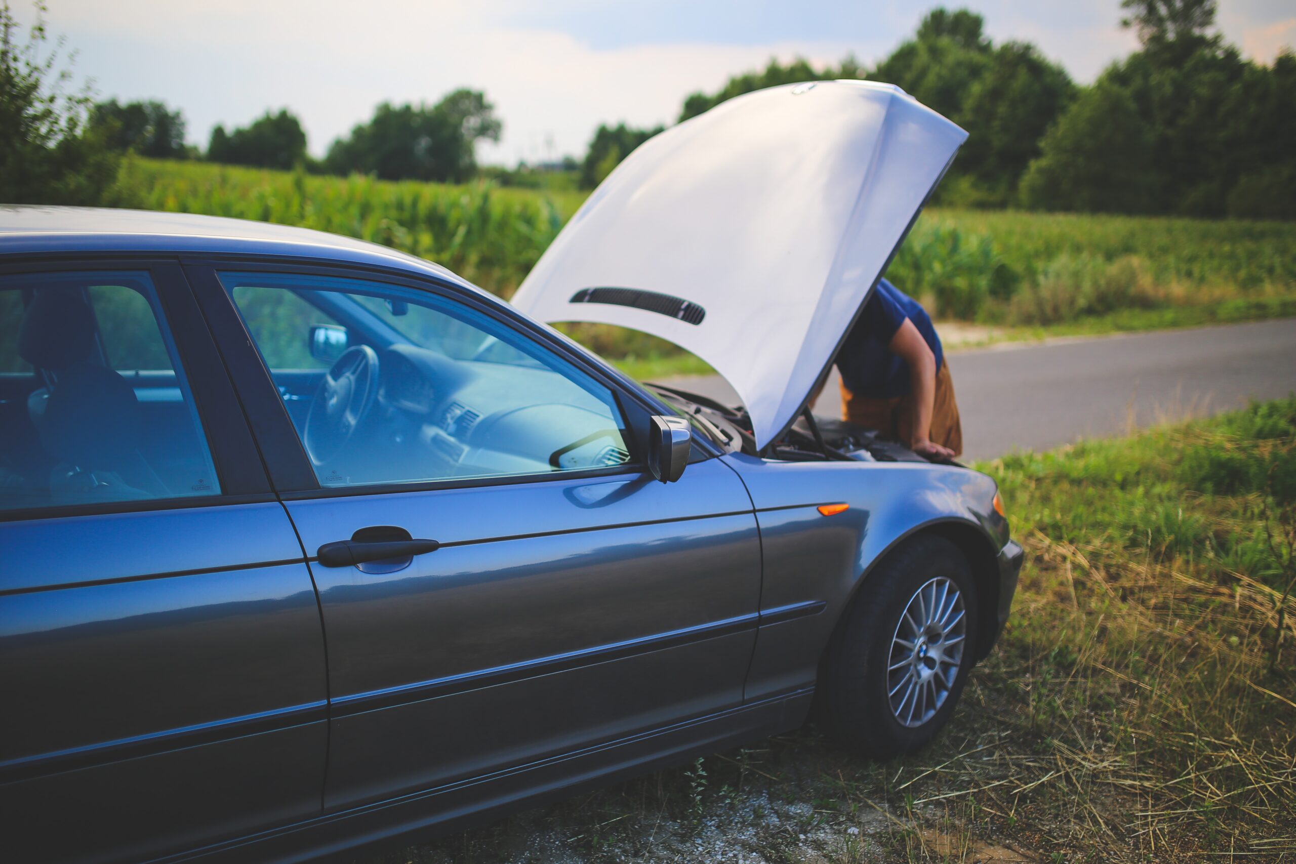 Millennial Gen Z working on broken down car