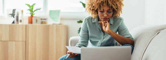 Woman sitting on sofa learning about financial terms