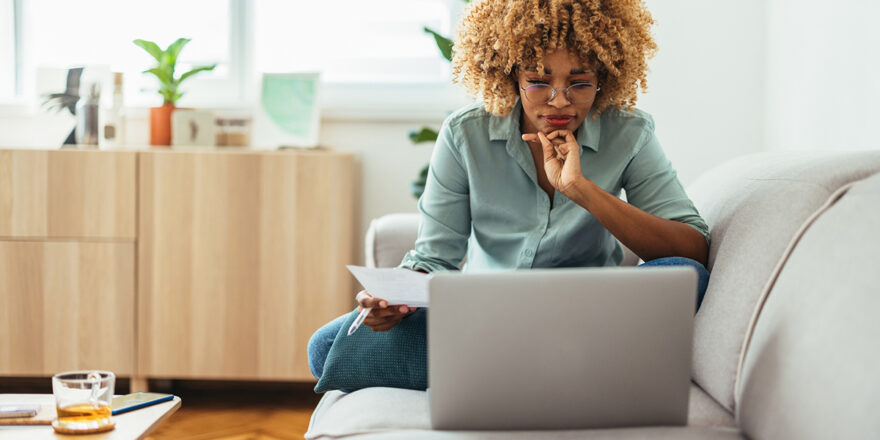 Woman sitting on sofa learning about financial terms