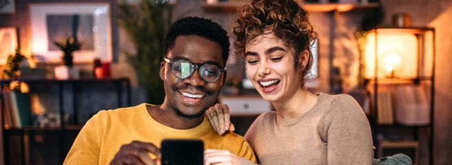 Young couple using smart phone to improve credit score