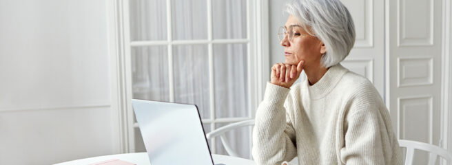 Senior woman thinking about whether to save or pay off debt first