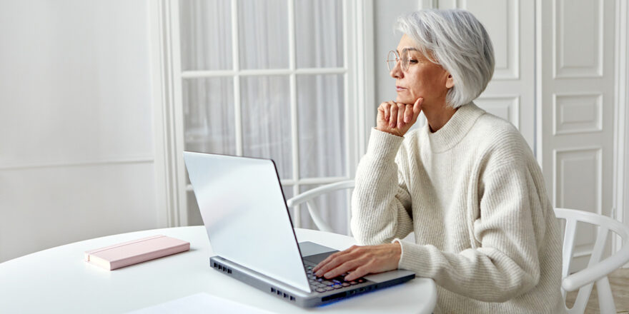 Senior woman thinking about whether to save or pay off debt first