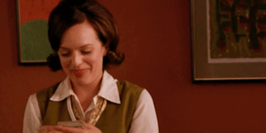 Woman smiling looking at money - Upstart Personal Loans