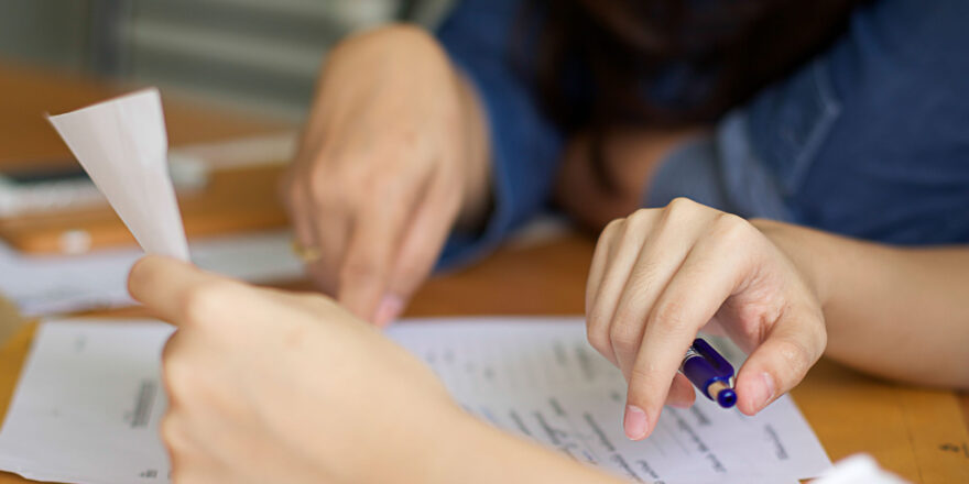 Two People Looking at Paperwork - Upstart Personal Loans