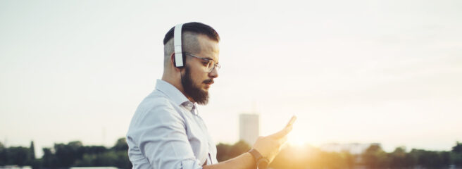 Man listening to his phone - Upstart Personal Loans