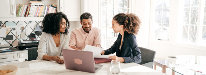 Couple speaking to their accountant.