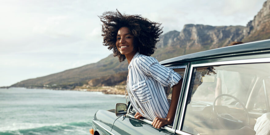 Woman hanging outside a car window - Upstart Personal Loans