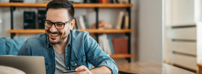 Portrait of a happy man shopping online.