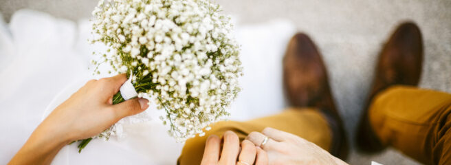 Couple holds hands at wedding ceremony