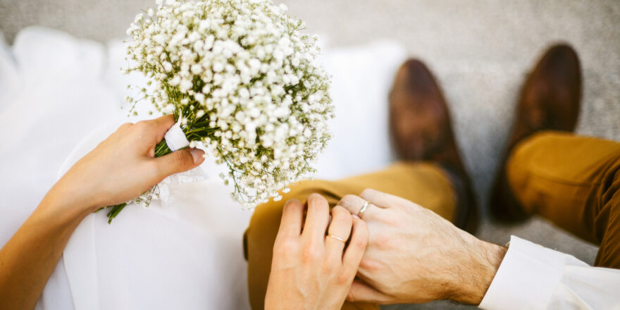 Couple holds hands at wedding ceremony