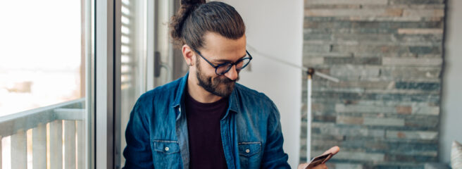 A man sits at his computer and calculates the cost of credit