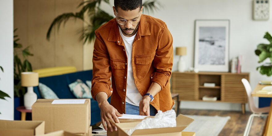 Man packs his belongings in boxes in preparation for a move