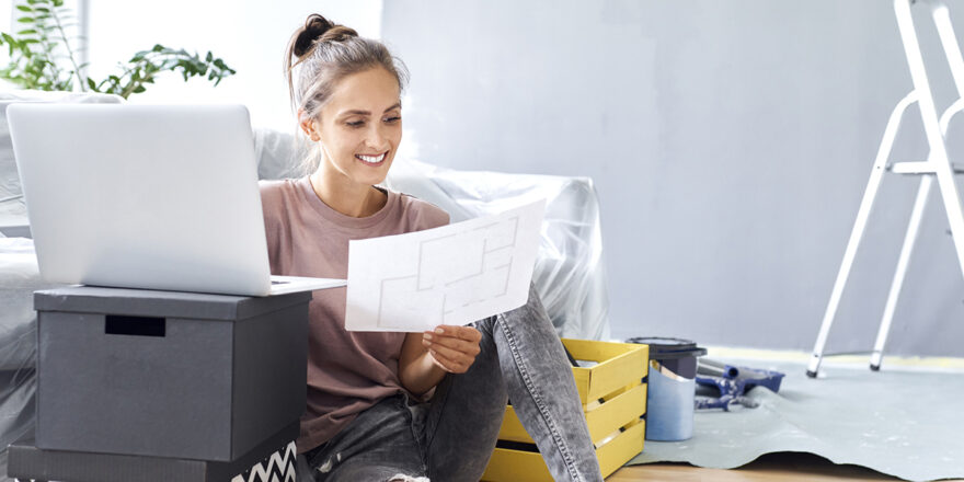 Woman planning DIY home projects and researching home improvement loans on laptop.