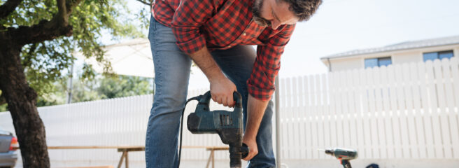 A man builds a deck using financing from a home improvement loan