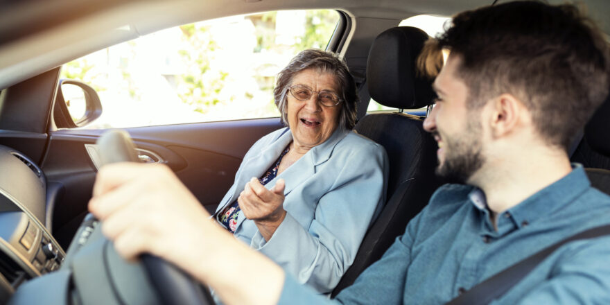 A man drives a car while a woman sits in the passenger seat and considers becoming a co-signer