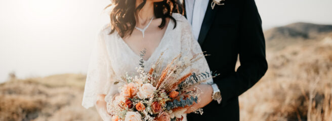 A married couple poses for photos after using a wedding loan to finance their wedding