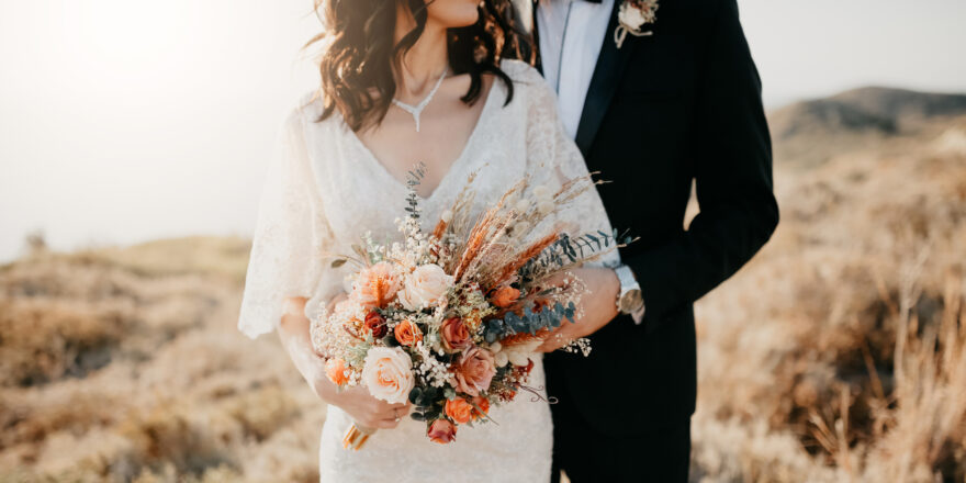 A married couple poses for photos after using a wedding loan to finance their wedding