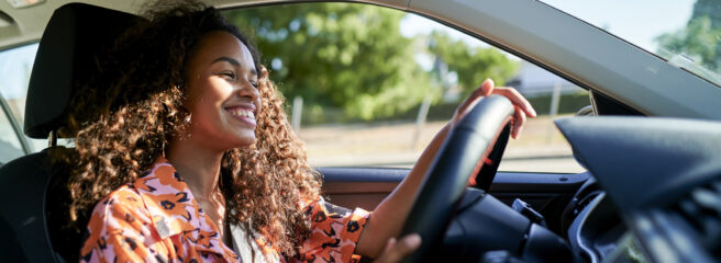 Smiling woman driving a car