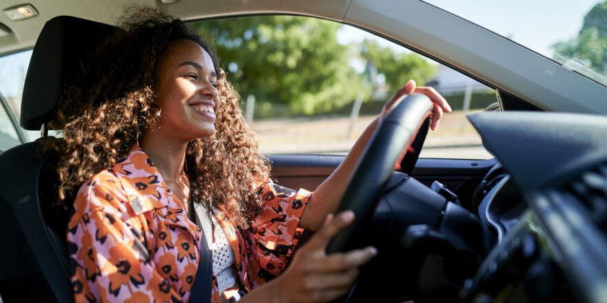 Smiling woman driving a car