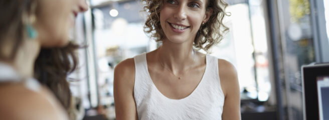 A woman uses a credit card to make a purchase in a retail store