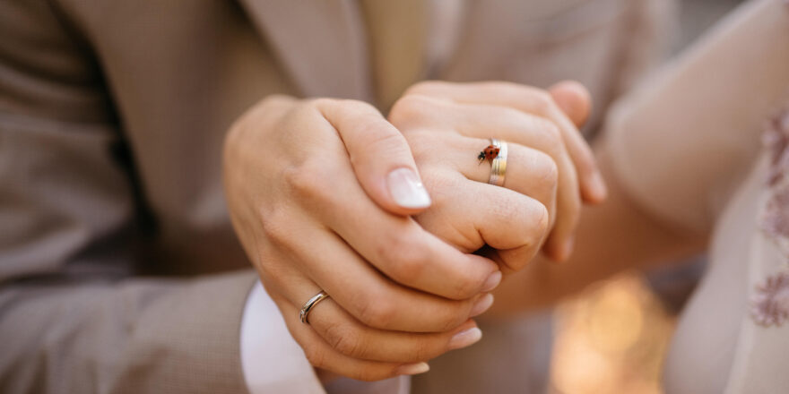 Married couple holds hands for photographer