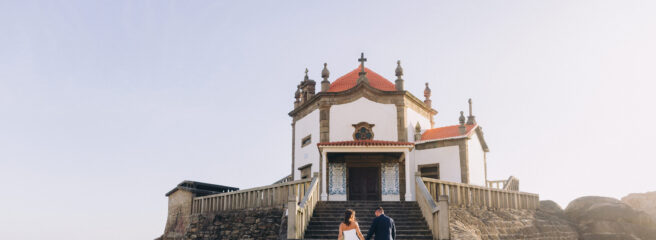 A newly married couple climbs the stairs outside of a destination wedding venue