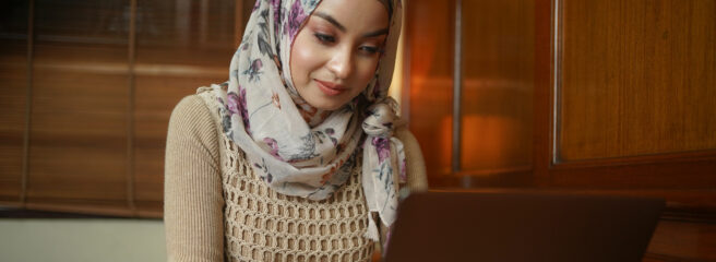 A woman uses her laptop to check her credit score