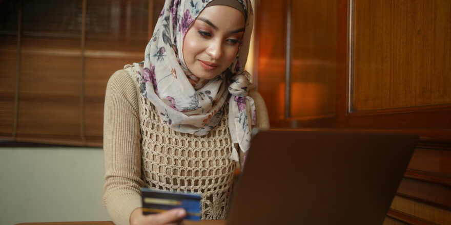 A woman uses her laptop to check her credit score