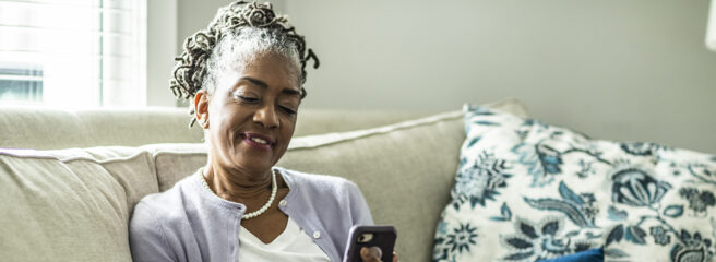 Senior woman using her phone to learn about loans and credit
