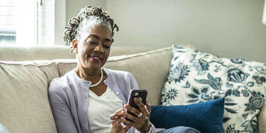 Senior woman using her phone to learn about loans and credit