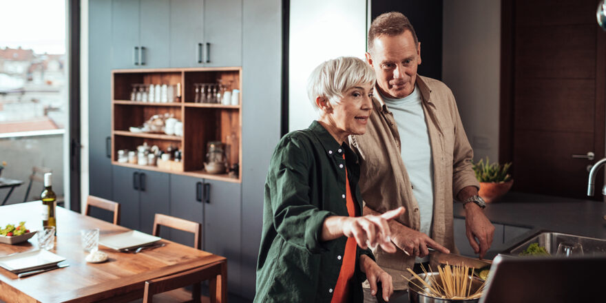 Mature couple in a kitchen talking about financing a kitchen remodel