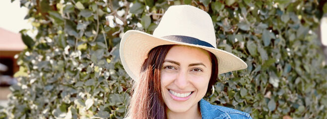 Young woman in a blue shirt who took out a personal loan through Upstart