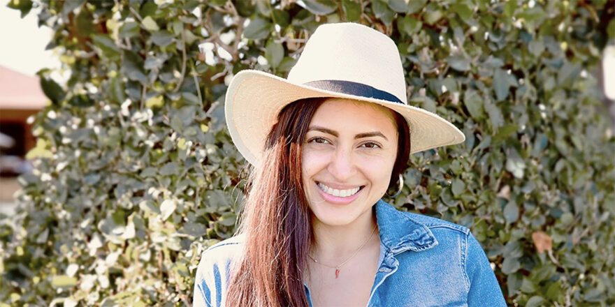 Young woman in a blue shirt who took out a personal loan through Upstart