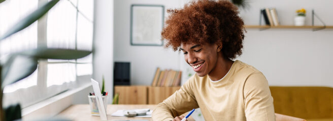 Young adult African American learning about personal loan prequalification at a desk