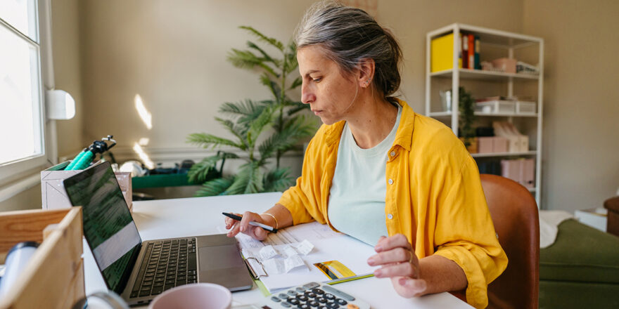 A woman calculating and managing credit card debt