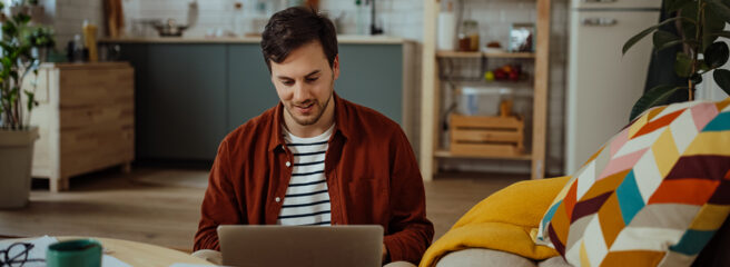 Young man learning about personal loan and collateral on a laptop