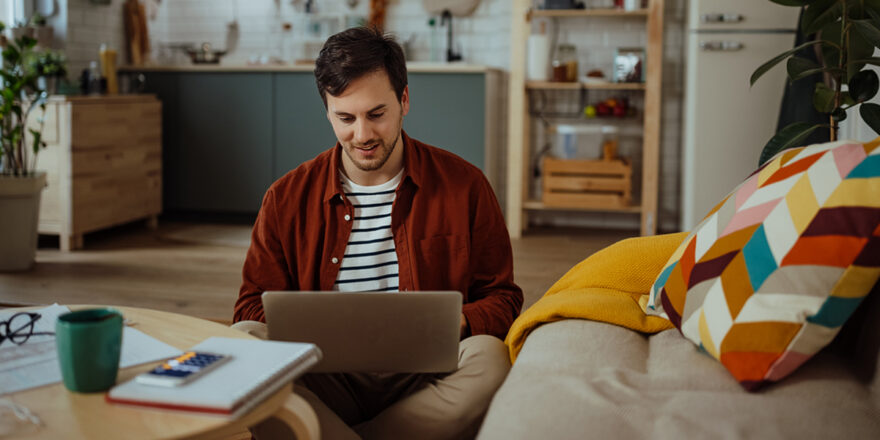 Young man learning about personal loan and collateral on a laptop