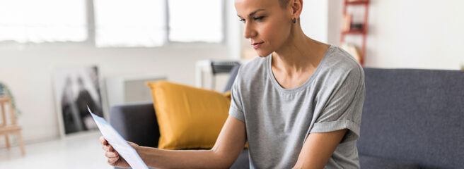 Middle age woman looking at paperwork about promissory note