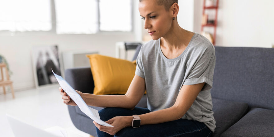 Middle age woman looking at paperwork about promissory note