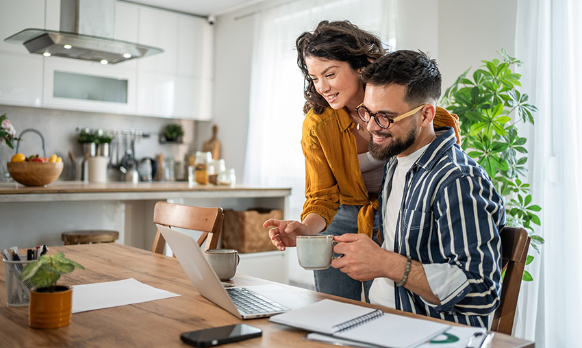 Couple sitting at their kitchen table accessing an Upstart home equity line of credit