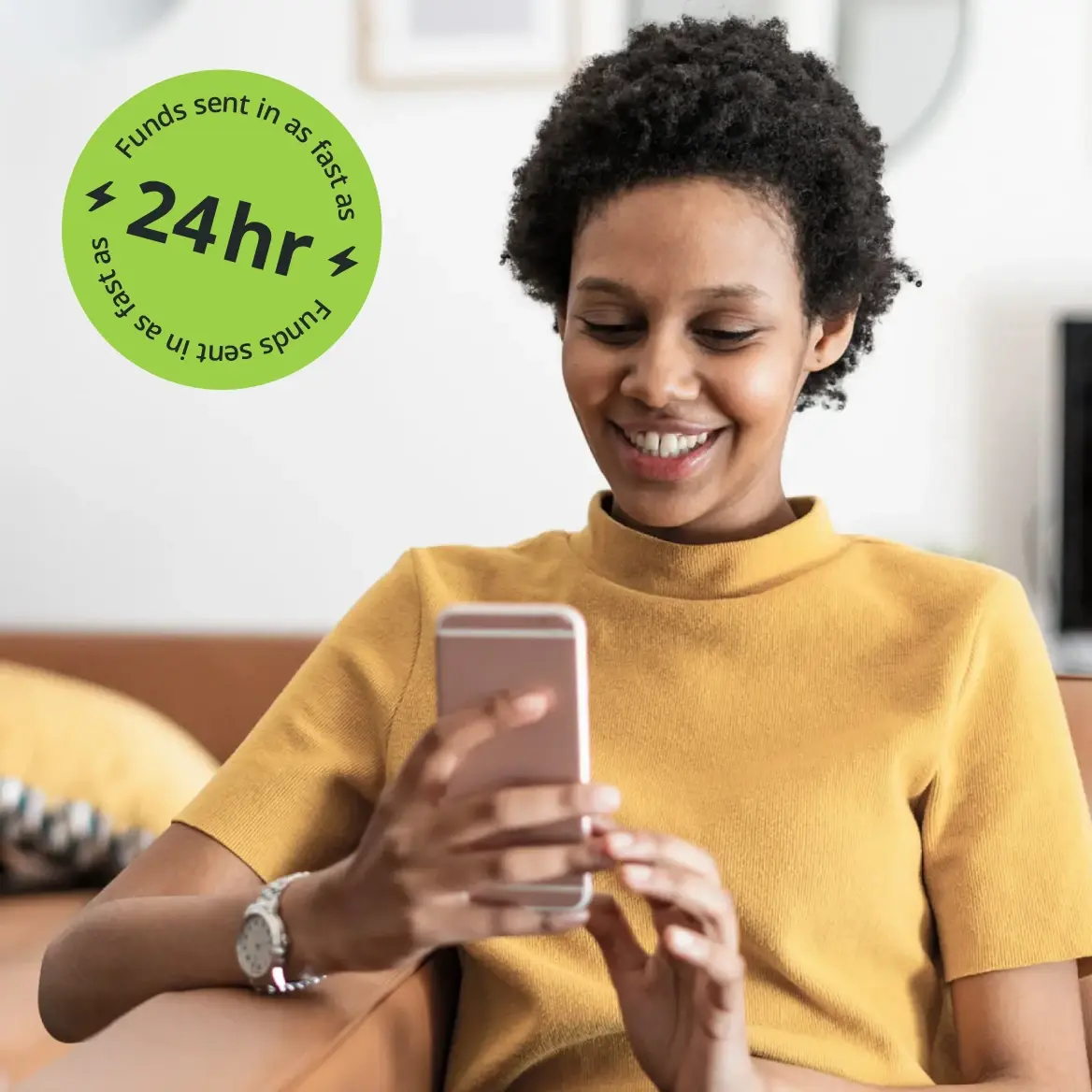 a woman looking at her phone and smiling