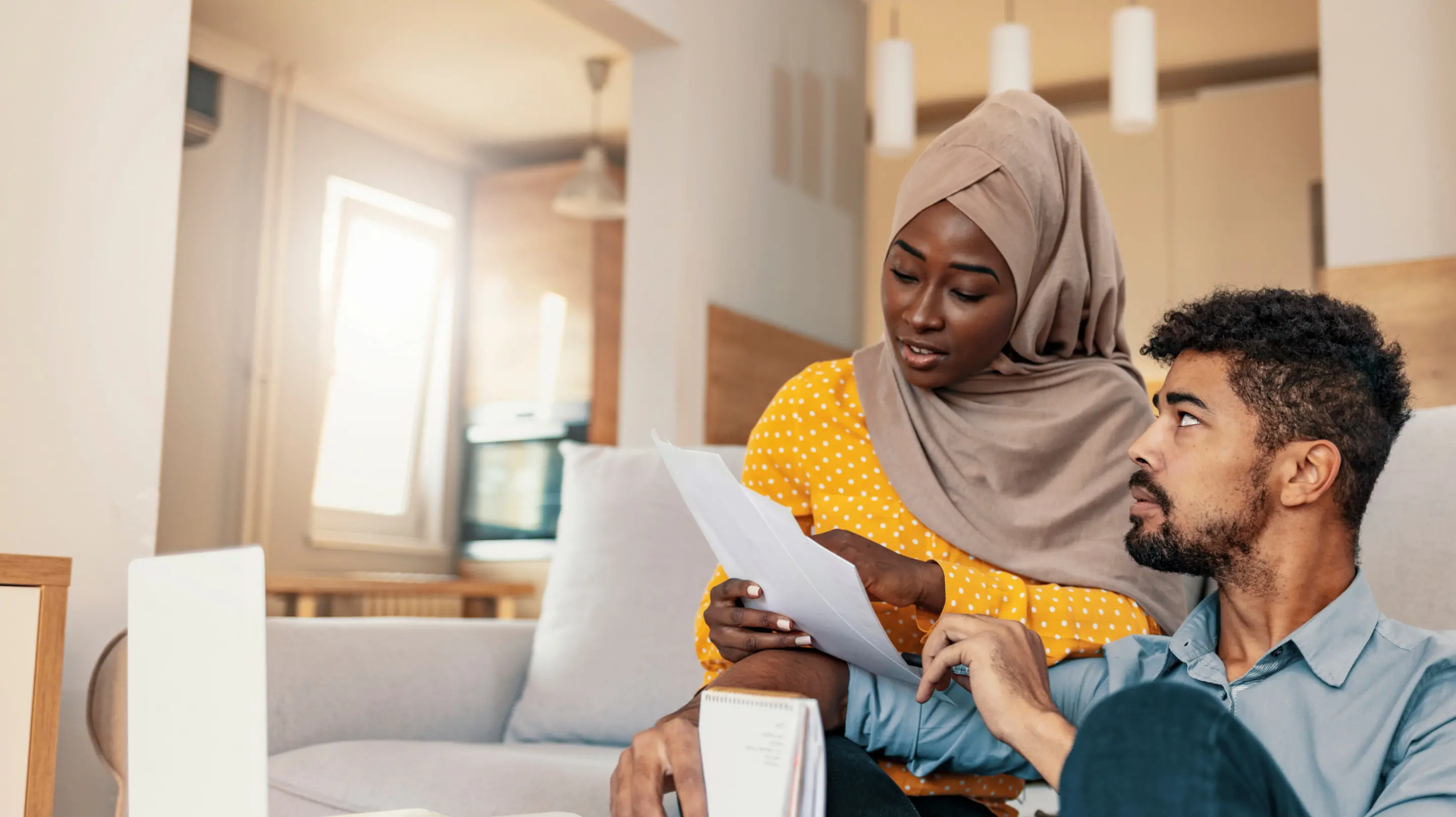 Couple reading about Upstart debt consolidation loan