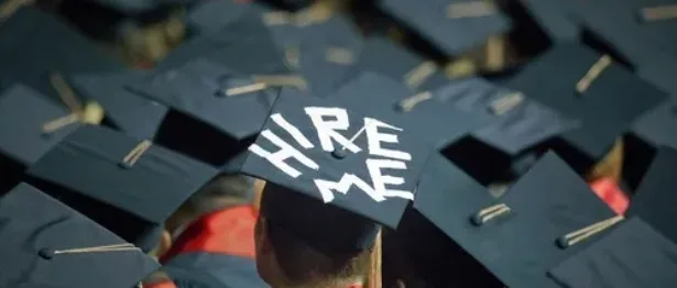 College student with “Hire Me” on his hat - Upstart Personal Loans