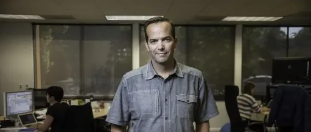 Man in collared shirt in an office - Upstart Personal Loans
