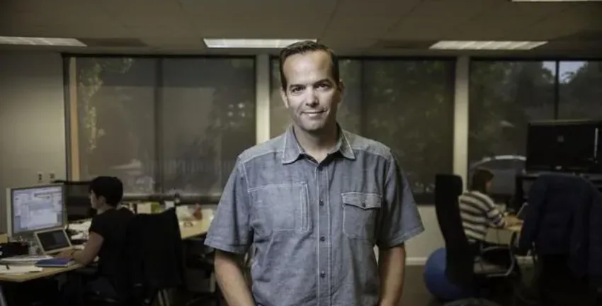 Man in collared shirt in an office - Upstart Personal Loans