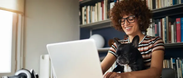 Woman and her dog working from home - Upstart Personal Loans