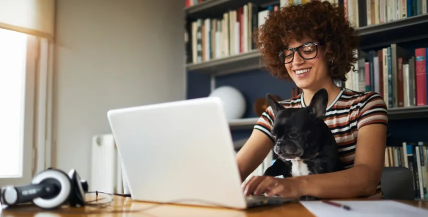 Woman and her dog working from home - Upstart Personal Loans